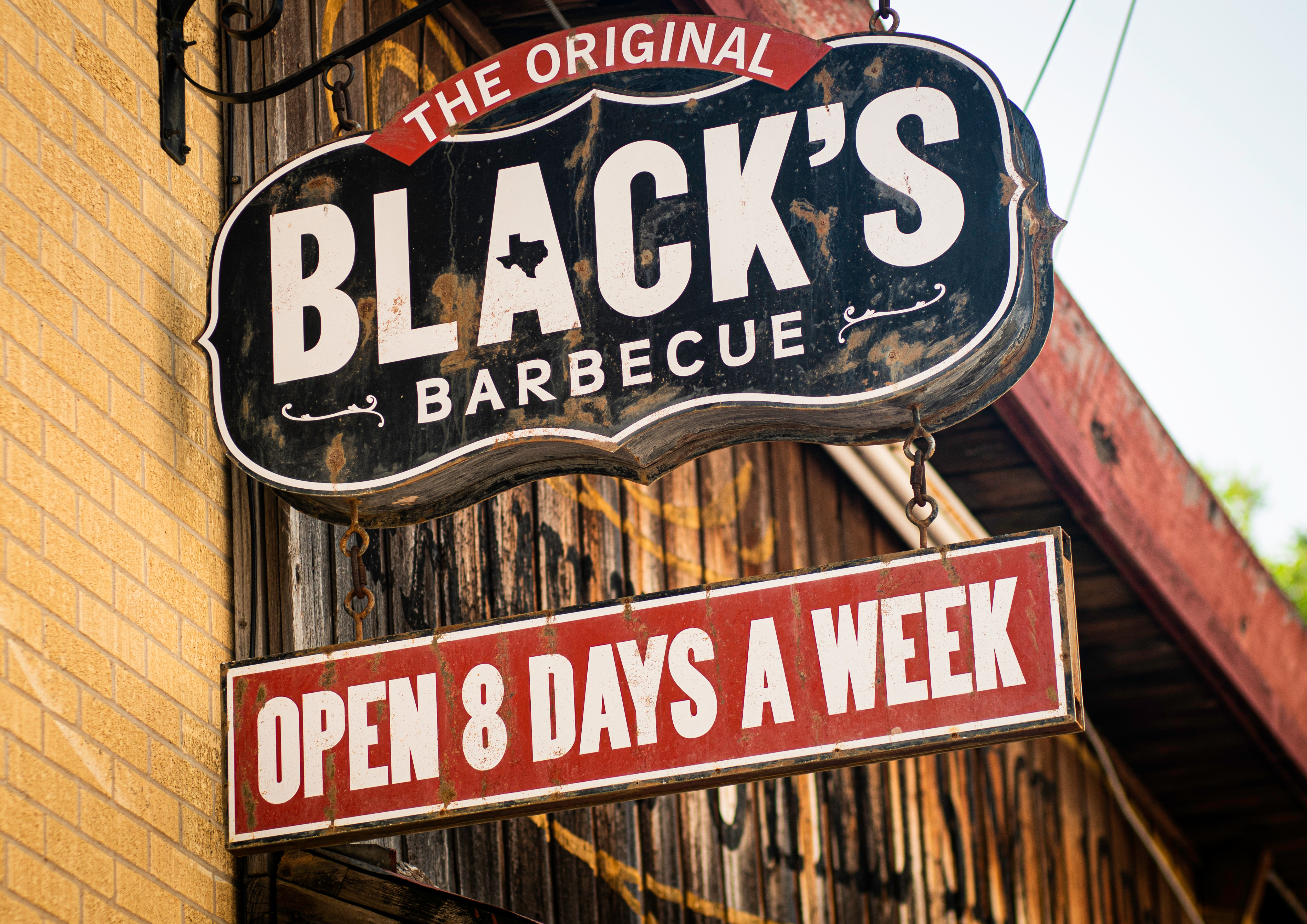Black's Barbecue sign in Austin, Texas. The sign also states that the restaurant is open 8 days a week.